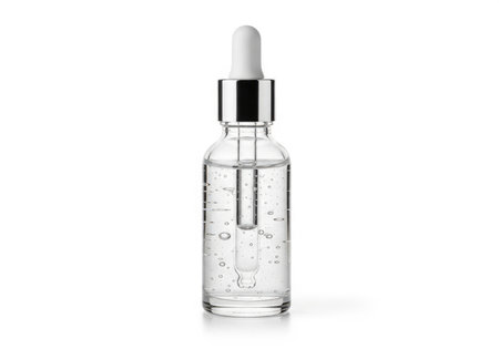 Close-up of a clear glass dropper bottle containing transparent liquid with air bubbles, isolated. Ideal for beauty, skincare, medical, and scientific concepts.の素材