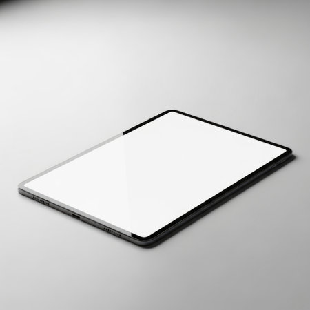 A minimalist image featuring a modern tablet with a clean blank screen angled on a neutral surface. This versatile visual is perfect for showcasing app designs presentations or digital media creation.の素材