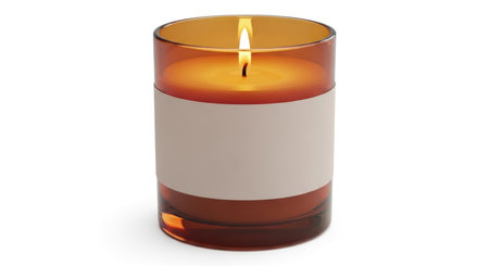 A lit candle in a glass and ceramic holder, isolated on a white background.の素材