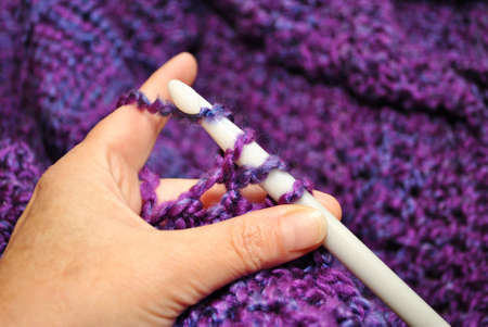 Crocheting with Purple and a Large White Hook の写真素材