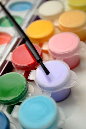 Multi Colored Paints with a Paint Brush on Topの写真素材