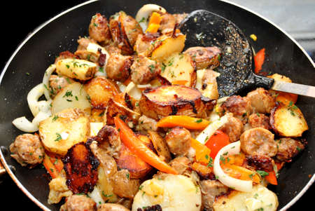 Cooking Sausage and Peppers with Potatoesの写真素材