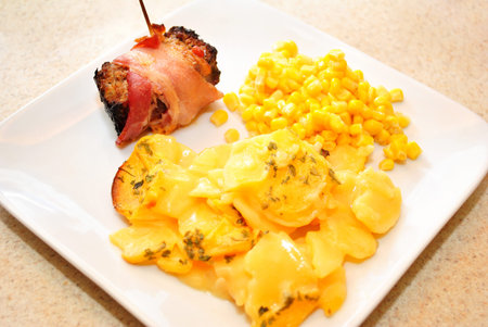 Gourmet Meal of Potato Casserole with Bacon Wrapped Meatloafの写真素材