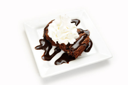 Cake Brownie with Chocolate Syrup and Creamの写真素材