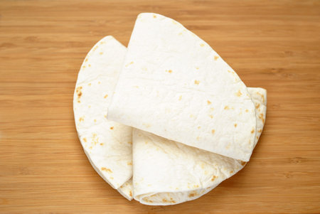 Tortillas Folded on a Wooden Table