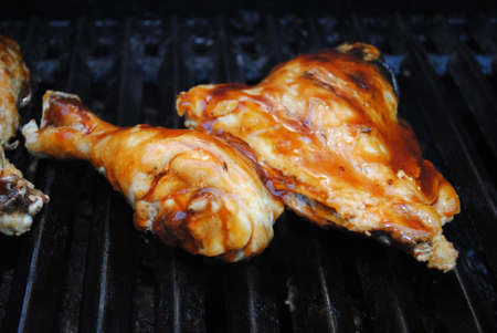 Barbequing a Saucy Chicken Leg and Thighの写真素材