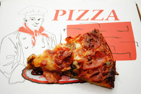 Meaty Pizza Slice on a Takeout Pizza Boxの写真素材