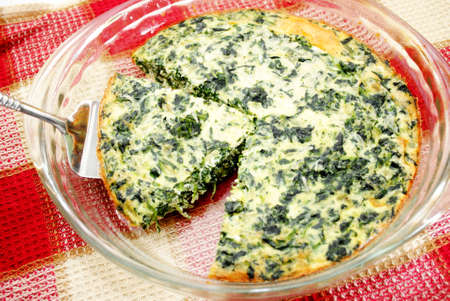 Serving Egg Quiche with Spinach and Cheeseの写真素材