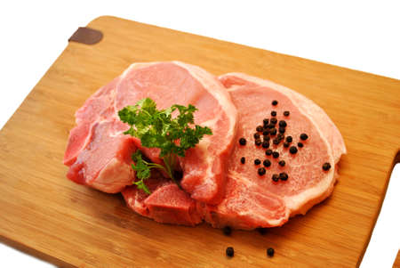 Fresh Lean Pork Chops on a Cutting Boardの写真素材