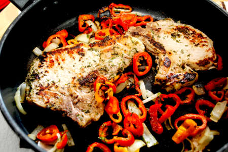 Cooked Pork Chops in a Pan with Onion and Mini Sweet Peppersの写真素材