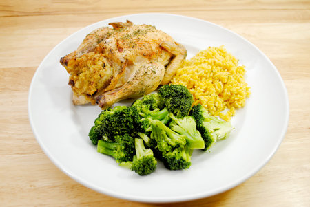 A Plated Healthy Dinner of Cornish Game Hen, Reice and Steamed Broccoliの写真素材