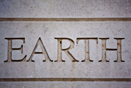 The Word Earth Carved Into a Cement Wallの写真素材