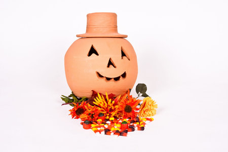 Halloween Jack-O-Lantern with flowers and candy on a white background.の写真素材