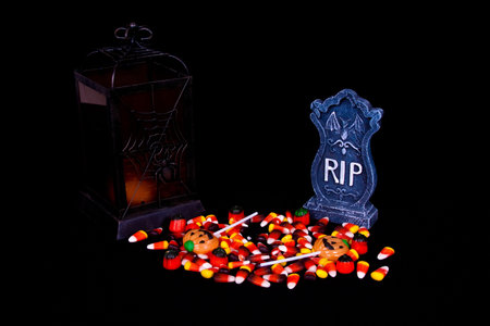 Halloween candy, lantern and gravestone