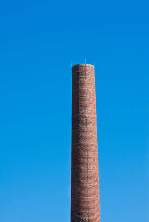 Smoke stack in a blue sky with no smokeの写真素材