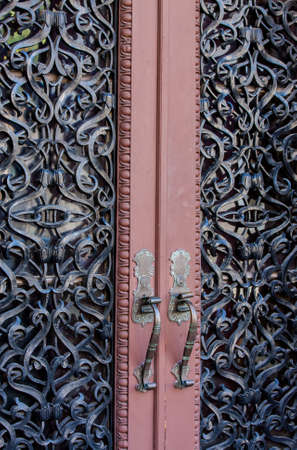Ornate wrought iron imbedded double entry doorsの写真素材