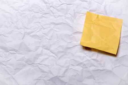 Blank Yellow paper posted on crumpled paper sheet with tack pin for text and background