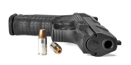 semi-automatic pistol on side with ammunition