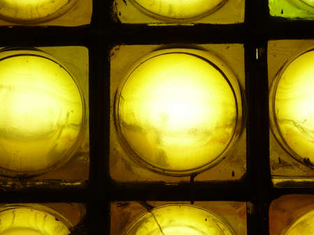 Background of few yellow glass bricks with round shapesの写真素材