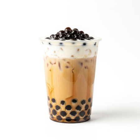 A delightful bubble tea beverage is presented in a clear plastic cup, showcasing its layered beverage and chewy tapioca pearls. The drink is topped with a creamy foam and garnished with dark, glossy pearls, offering a visually appealing and thirst-quenching treat for any occasion.の素材