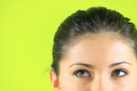 Close-up portrait of a beautiful teenager. Looking up into the corner.の写真素材