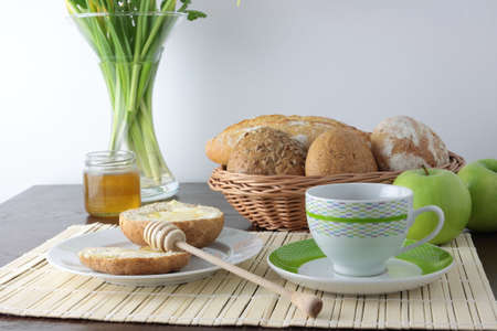 Fresh bread With Honey, cup of cofee And Green Applesの写真素材