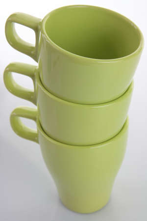 Three empty green mugs isolatedの写真素材