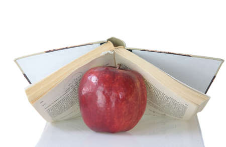 Red apple on book isolated on whiteの写真素材
