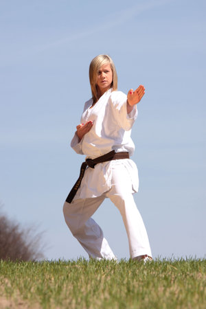 Karate blond girl training outdoorの写真素材