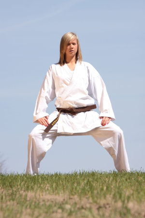 Karate blond girl training outdoorの写真素材