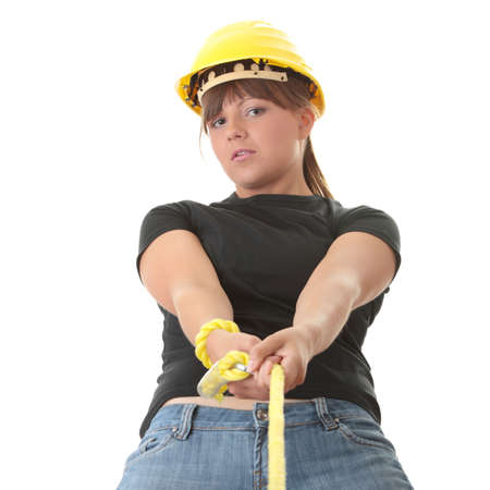 Young woman builder holding yellow ropeの写真素材