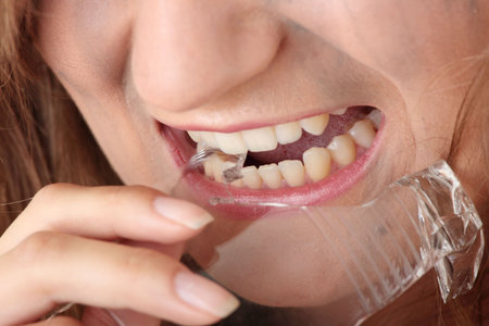 Angry dengerous princess in white dress eating a broken glass - horror conceptの写真素材