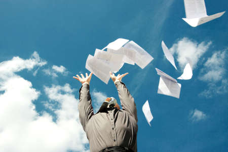 A business man freeing himself from his work loadの写真素材