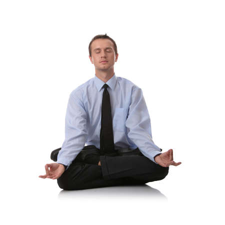 Businessman sitting in lotus position, Isolated against white backgroundの写真素材