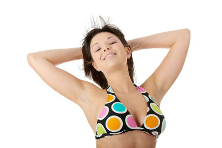 Happy beautiful sexy young woman in top of bikini and shorts, isolated on white の写真素材