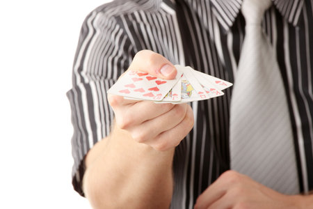 Young poker player with gun isolated on whiteの写真素材