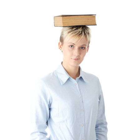 Teen student woman with book on her head, isolated on white
