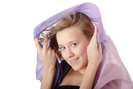 Young beautiful blond teen woman in elegant, evening, black dress dancing with wind (hair blowing), isolated on white background.の写真素材