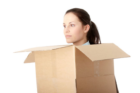 Thinking inside a box. Young business woman in cardboard box, isolated on white