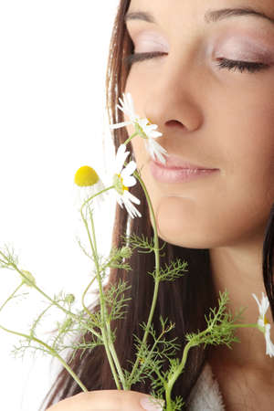 Calm portrait of young teen woman in bathtub with daisyの写真素材