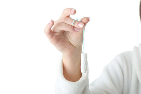 Young woman holding tampon,isolated on whiteの写真素材