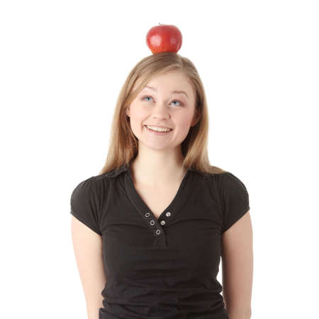 Beautiful student woman have apple on her head - learning conceptの写真素材