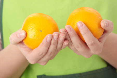 Beautiful young woman with orange. Isolated over white background
の写真素材