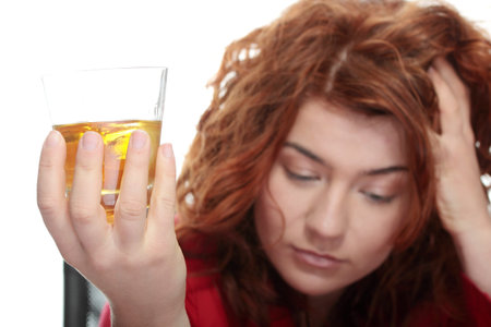 Alone young woman in depression, drinking alcohol (burbon)