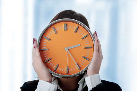 Businesswoman with clock - time conceptの写真素材