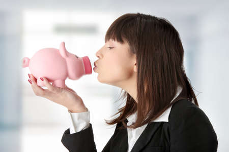 Woman Holding Piggy Bank, isolated on whiteの写真素材