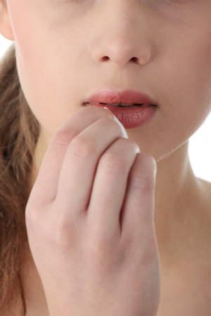 Woman cleaning her face with cotton pads. Lips close-up の写真素材