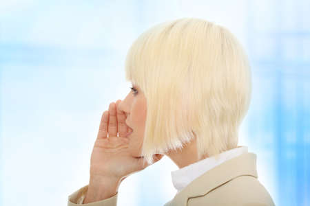 Young businesswoman talking gossip,Over abstract blue background の写真素材