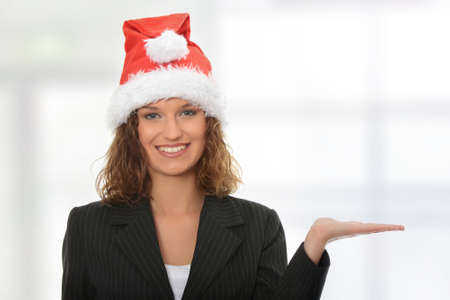 Beautiful business girl wearing santa's cap の写真素材