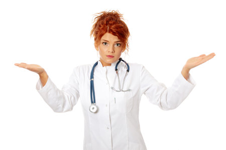 Female doctor or nurse don't know what to do, isolated on whiteの写真素材